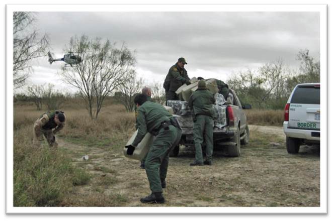 Four Custom and Border Protection Agents patrolling the south Texas Border in vehicles with a helicopter flying overhead