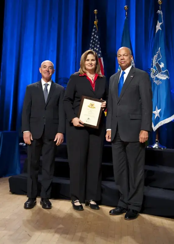 Secretary of Homeland Security Jeh Johnson and Deputy Secretary of Homeland Security Alejandro Mayorkas presented the Secretary's Unit Award to Wendy DeLapp