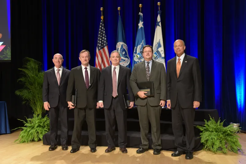 Secretary of Homeland Security Jeh Johnson and Deputy Secretary of Homeland Security Alejandro Mayorkas presented the Secretary's Meritorious Silver Service Medal for the Apex Border Enforcement Analytics Program Team to Stephen J. Dennis, Shane M. Cullen, Christopher T. Featherston, Nov. 3, 2015.