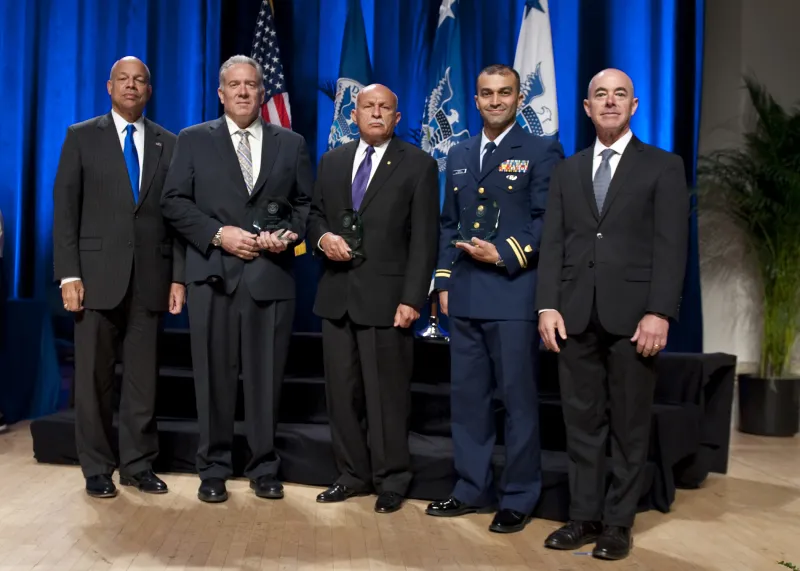 Secretary of Homeland Security Jeh Johnson and Deputy Secretary of Homeland Security Alejandro Mayorkas presented the Secretary's Unit Award to the U.S. Coast Guard's Maritime Intelligence Fusion Center, Intelligence Watch Officer Team Lt. Timothy S. Williams, Lt. James D. Phillips, Lt. Jeffrey T. Melville, Lt. Alfonso V. Kealy, Lt. Justin A. Parker, Lt. j.g. Judge Michael R. Vives, Ensign Thomas E. Peebles, Christopher M. Henry, and Gilbert Lopez, and Daniel Brick, U.S. Customs and Border Protection.