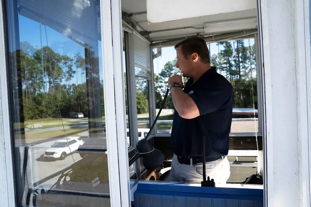 A FLETC instructor dispatches students to mock scenarios during driver training.